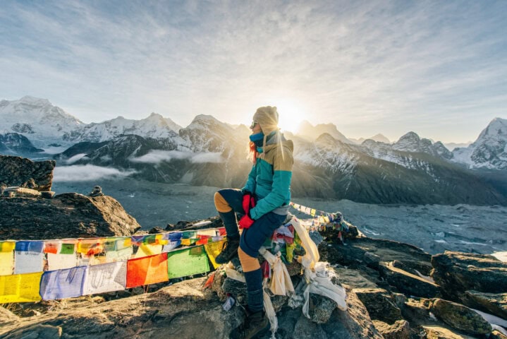 Female Tourist Hiking at Gokyo Ri mountain peak near gokyo lake during Everest base camp trekking in Nepal