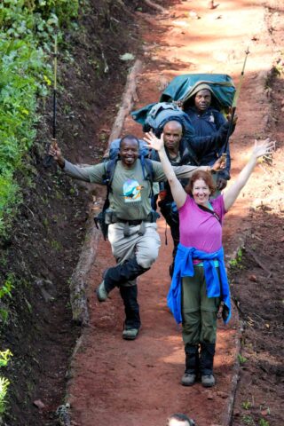 A group of Kilimanjaro porters and a traveler.