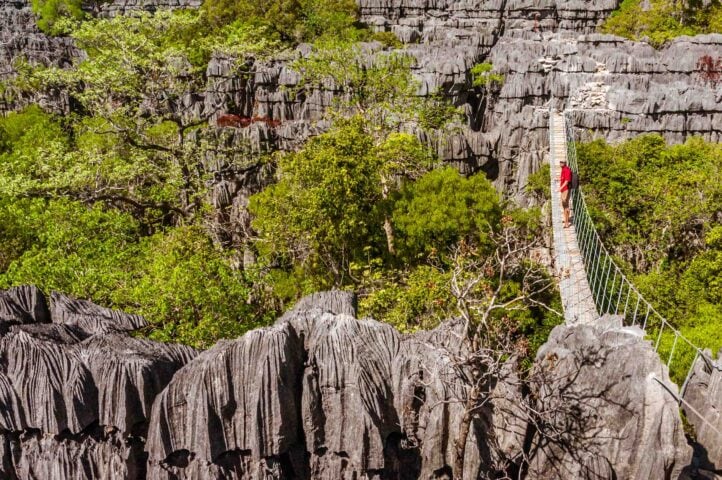 A tourist posing on a footbridge in Madagascar.