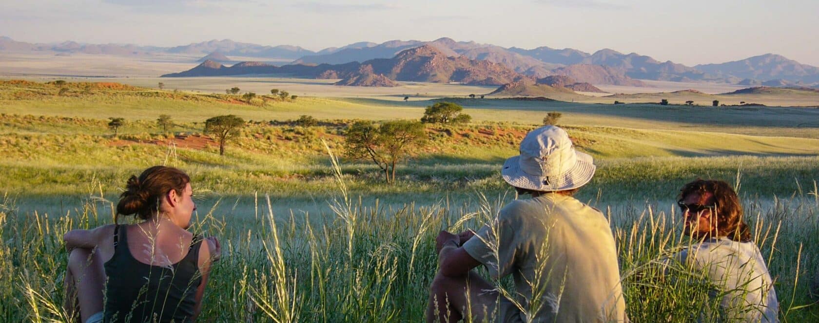 People sitting on a hill in Namibia.