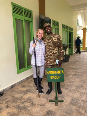 A man and woman posing for a picture during their hiking trip.