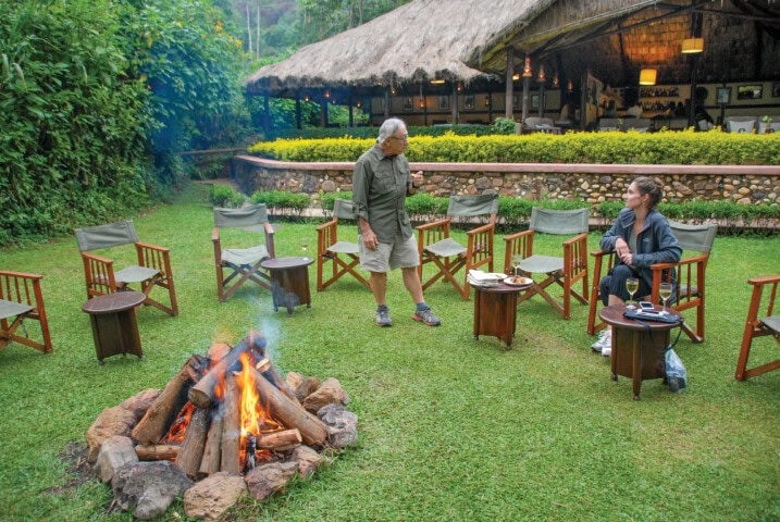 A group of travelers sitting around a fire, sharing stories from their trip.
